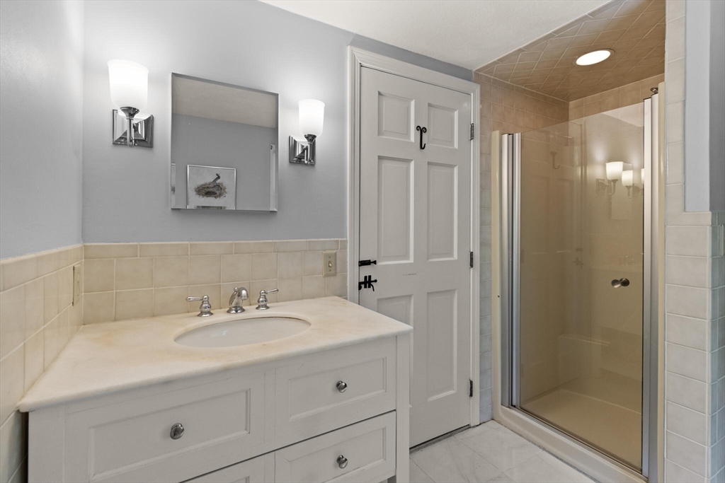 19 Pine Hill Circle Wakefield, MA 01880 - Photo 23 of 31 a bathroom with a sink shower and a mirror