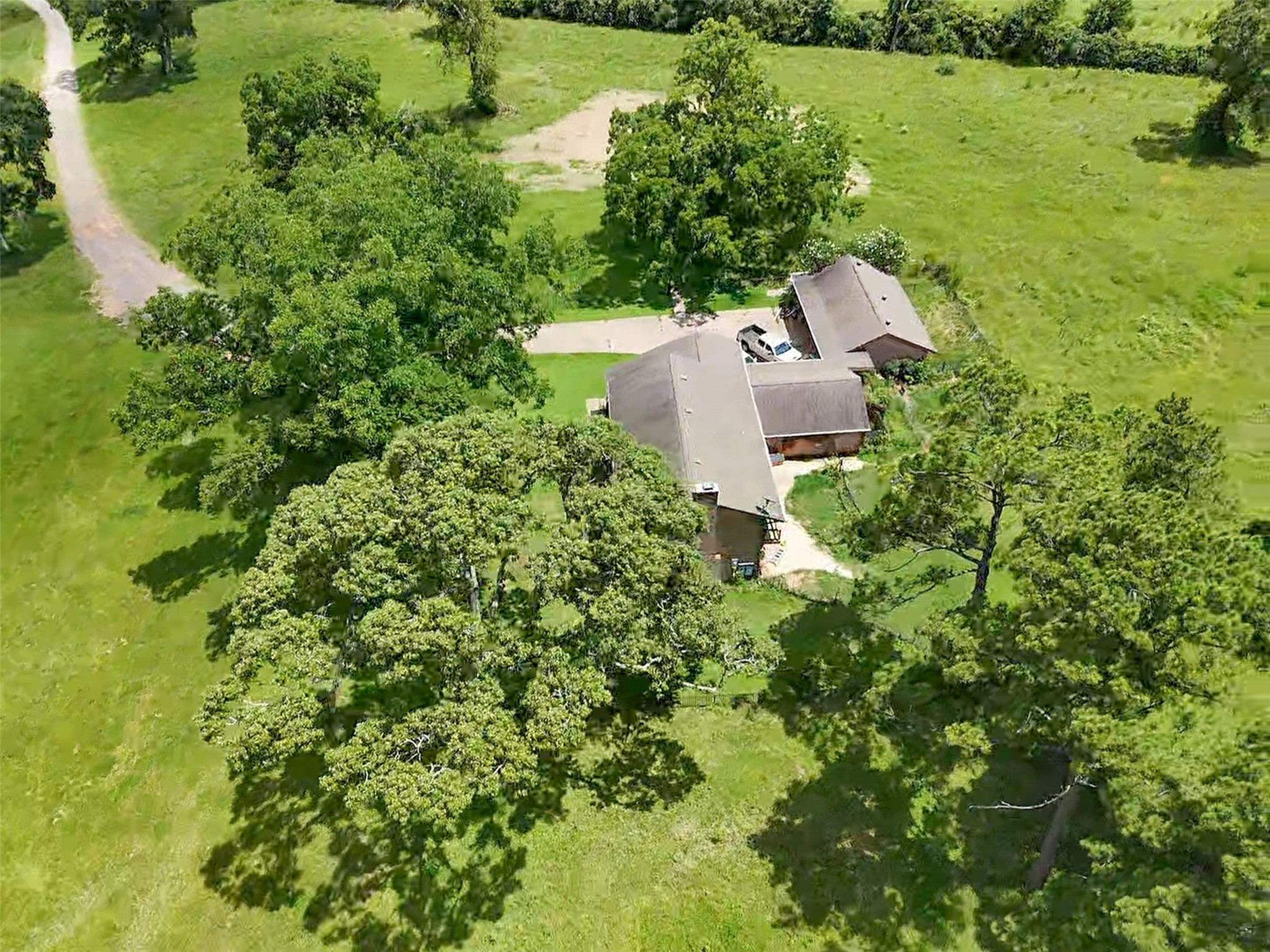 6605 Spring Branch Road Montgomery, TX 77316 - Photo 7 of 12 Nestled beneath a canopy of mature trees, the central homestead area offers shade, privacy, and a connection to the land from every angle.