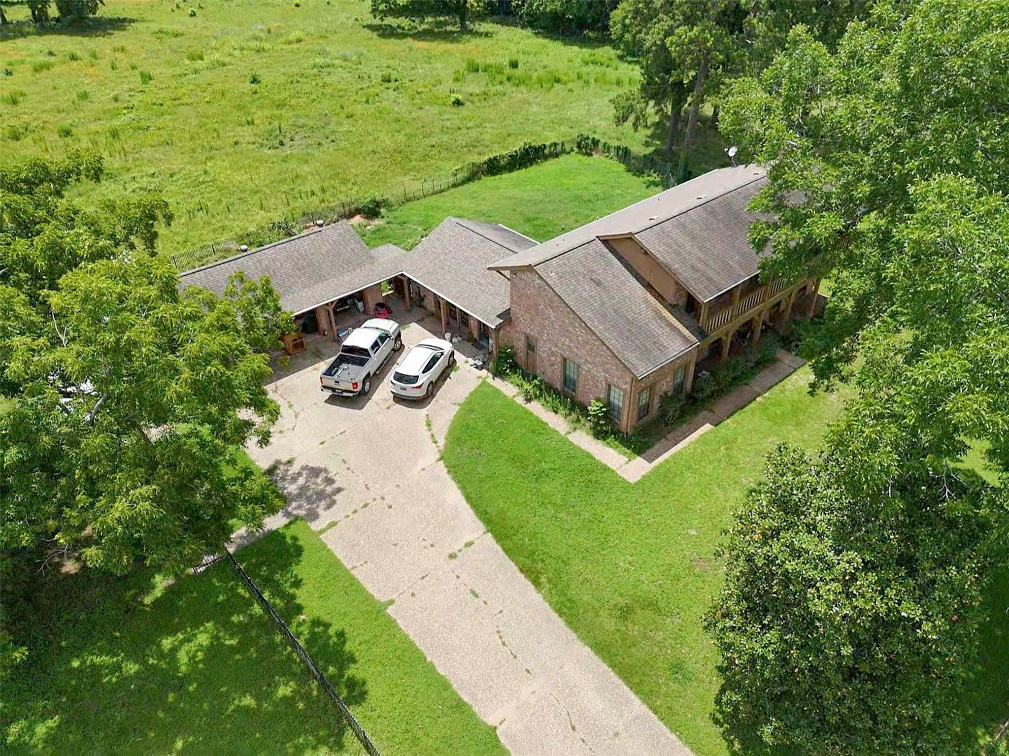 6605 Spring Branch Road Montgomery, TX 77316 - Photo 9 of 12 Functional and convenient—ample driveway space and adjacent buildings provide room for equipment, ranch vehicles, or workshop possibilities.