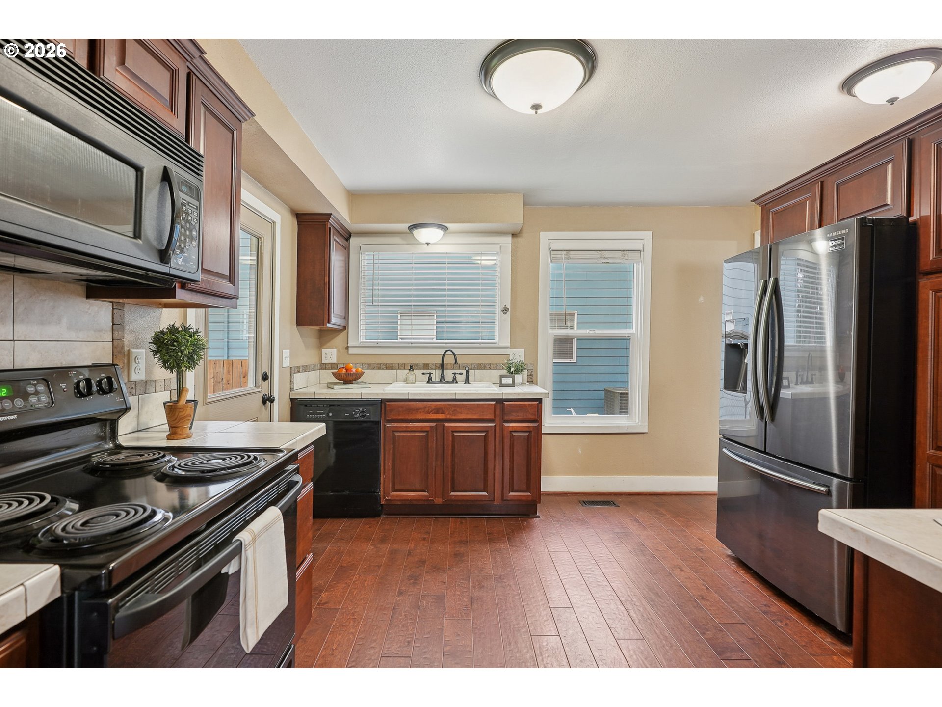 9306 Southwest 30th Avenue Portland, OR 97219 - Photo 11 of 30 a kitchen with a stove a sink and a refrigerator