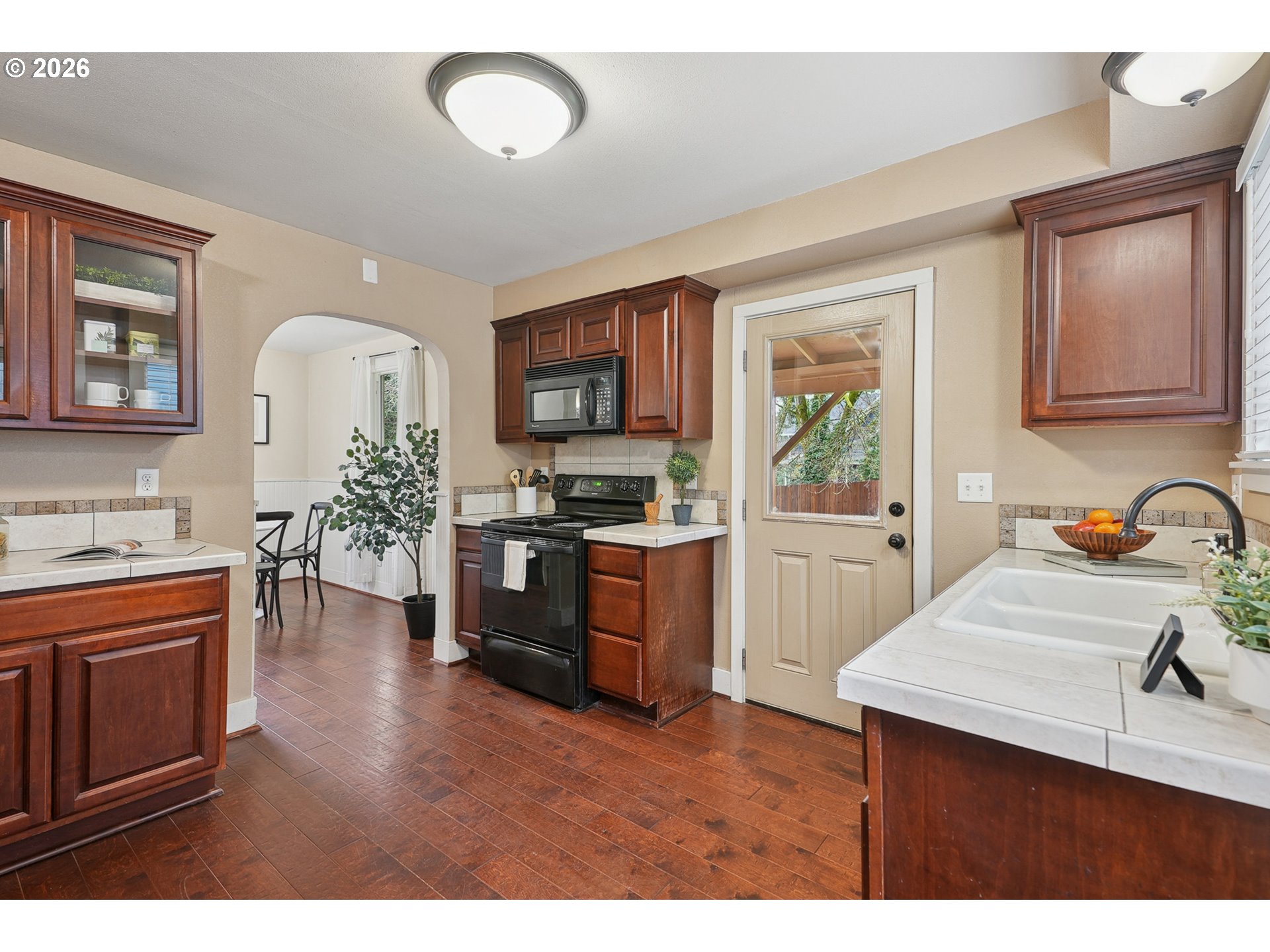 9306 Southwest 30th Avenue Portland, OR 97219 - Photo 12 of 30 a kitchen with a refrigerator and a stove top oven