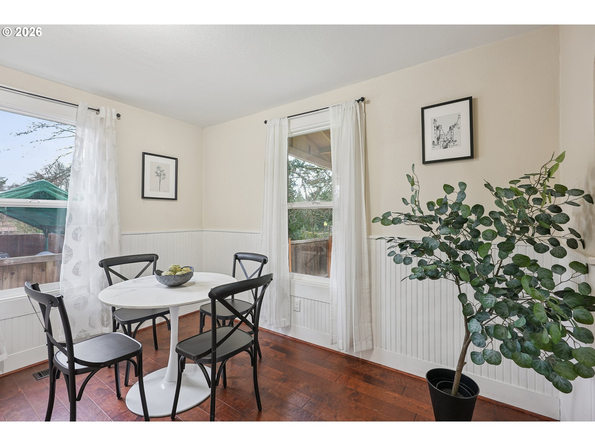 9306 Southwest 30th Avenue Portland, OR 97219 - Photo 13 of 30 a view of a dining room with furniture and a potted plant