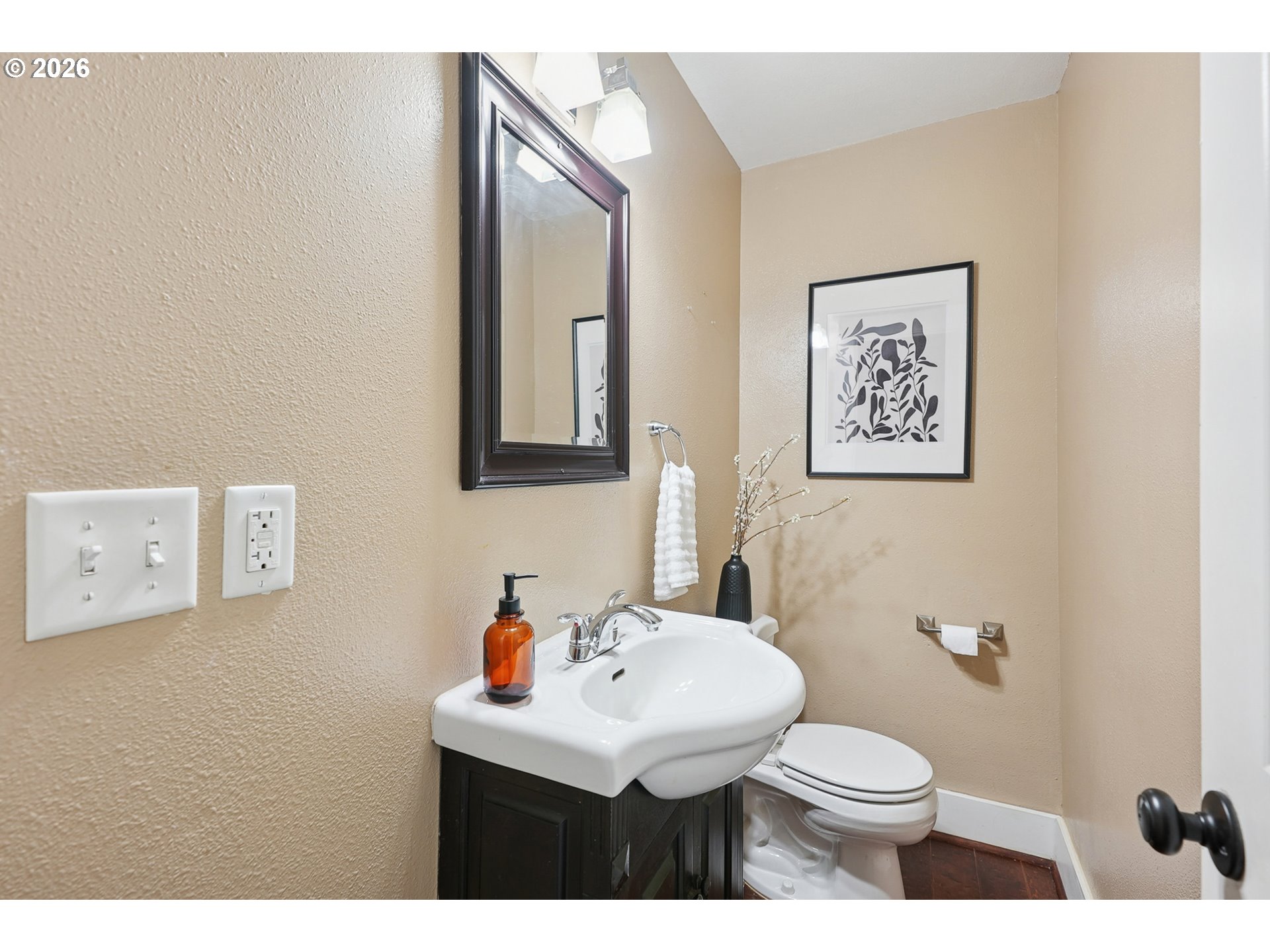 9306 Southwest 30th Avenue Portland, OR 97219 - Photo 16 of 30 a bathroom with a toilet a sink and mirror