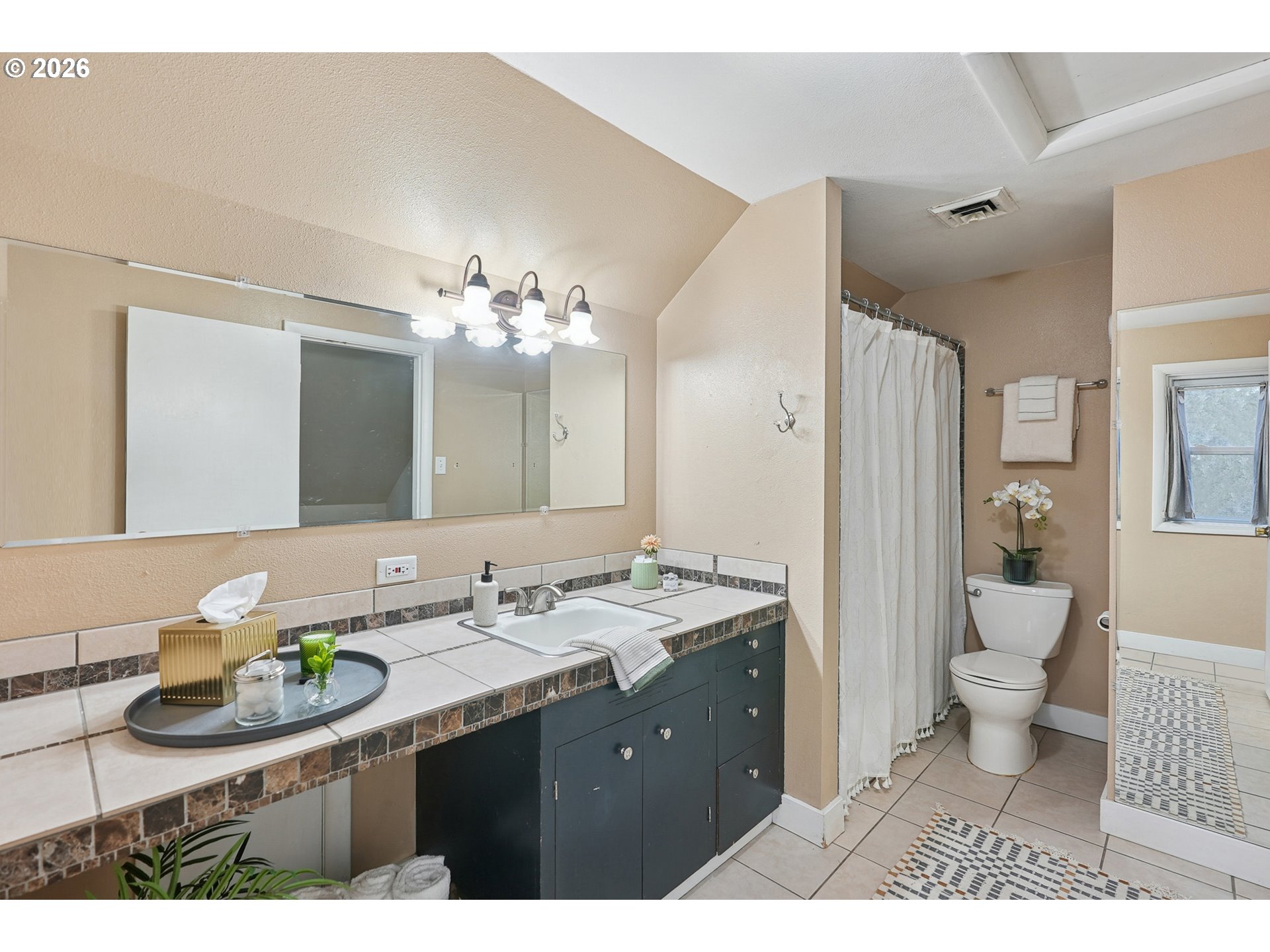 9306 Southwest 30th Avenue Portland, OR 97219 - Photo 18 of 30 a bathroom with a sink and a mirror
