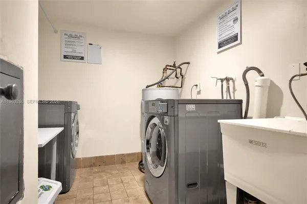 a view of a tennis ground with large buildings