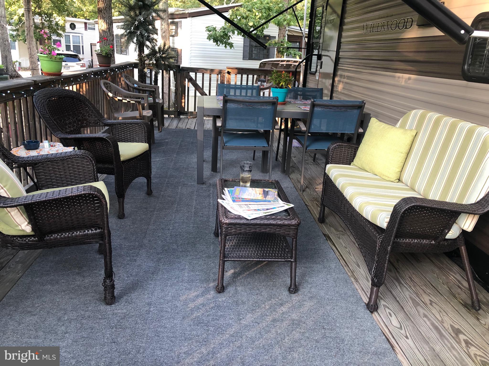 60 Corsons Tavern Road, Unit 342 Ocean View, NJ 08230 - Photo 16 of 19 a outdoor sitting area with couch and a table