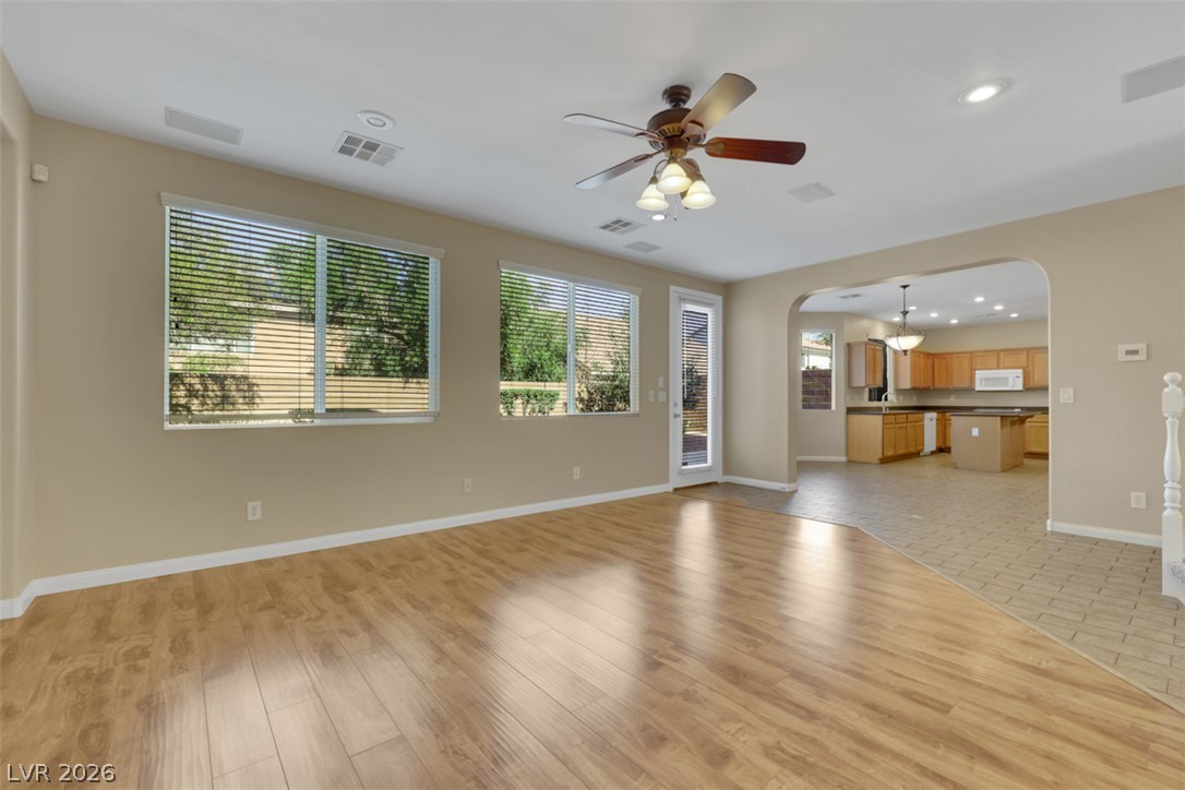 10328 Hawk Ravine Street Las Vegas, NV 89178 - Photo 9 of 55 An inviting open-concept living area flows into the kitchen, ideal for entertaining and daily life.
