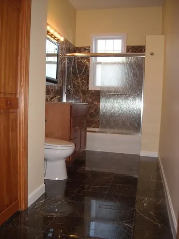 a bathroom with a toilet and a shower