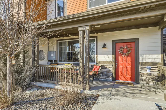 a view of a brick house with a small porch