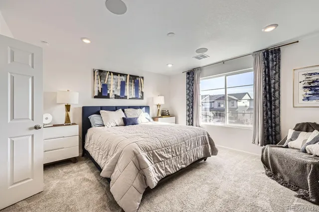 a bedroom with a large bed and a couch