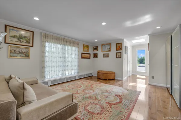 a bedroom with furniture and a large window