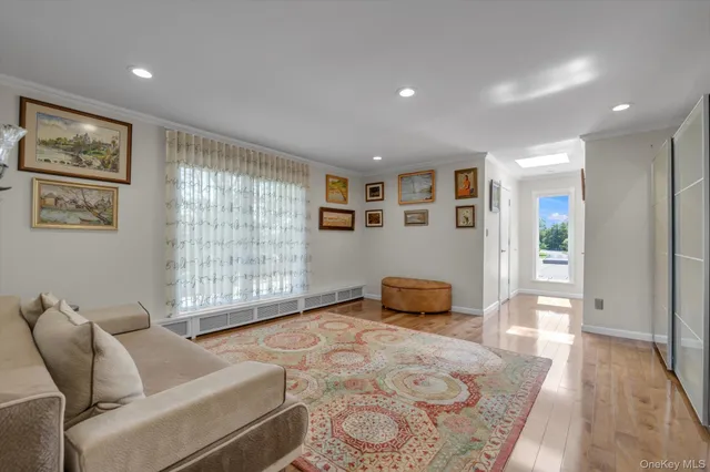 a bedroom with furniture and a large window