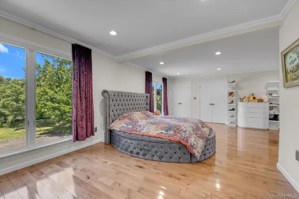 a spacious bedroom with a bed and a large window