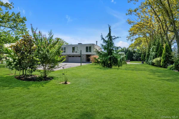 a view of a garden with a house in the background