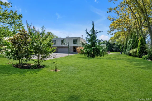 a view of a garden with a house in the background