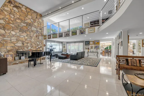 a view of a patio with table and chairs barbeque potted plants and large tree