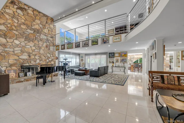 a view of a patio with table and chairs barbeque potted plants and large tree