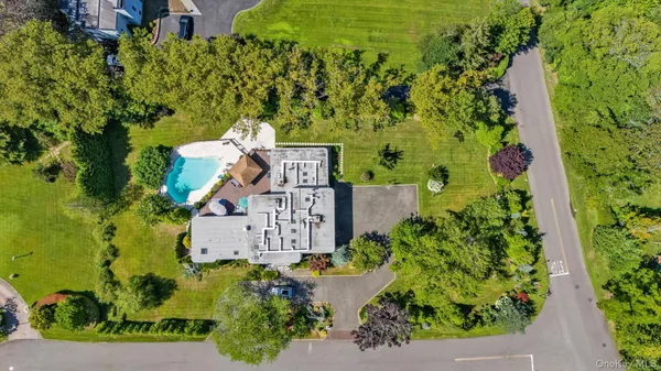 an aerial view of a house with a yard and garden