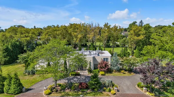 an aerial view of a house with garden space and outdoor seating