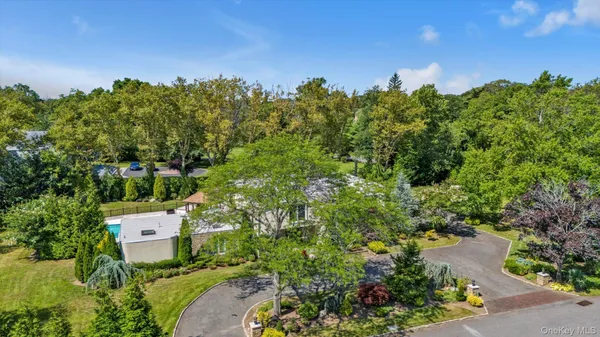 an aerial view of a house with a yard swimming pool and outdoor seating