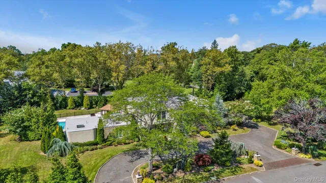an aerial view of a house with a yard swimming pool and outdoor seating