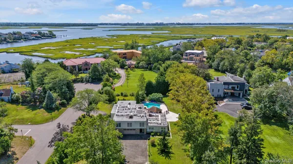 an aerial view of residential houses with outdoor space and swimming pool