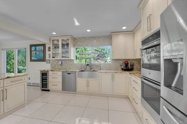 a kitchen with a refrigerator and a sink