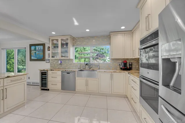 a kitchen with a refrigerator and a sink