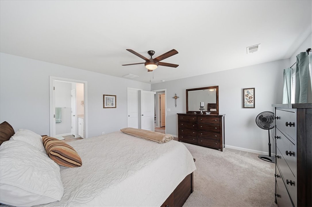 208 Grassy Creek Way Pendleton, SC 29670 - Photo 27 of 43 A quiet retreat, this bedroom offers plush carpet flooring and a ceiling fan for year-round comfort.