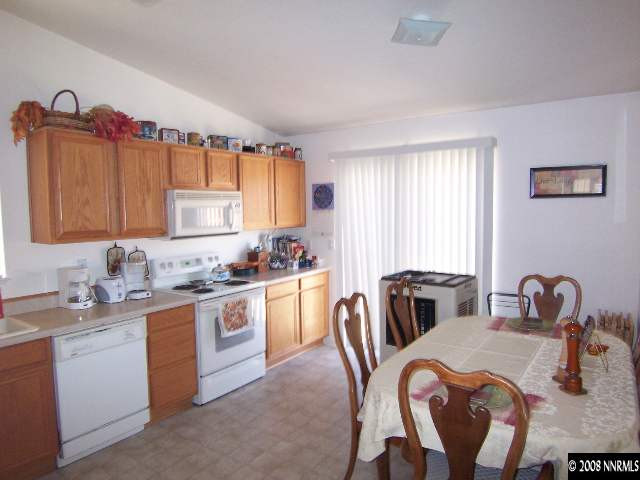 18031 Hazelnut Drive Reno, NV 89508 - Photo 2 of 9 a kitchen with a table chairs sink and cabinets