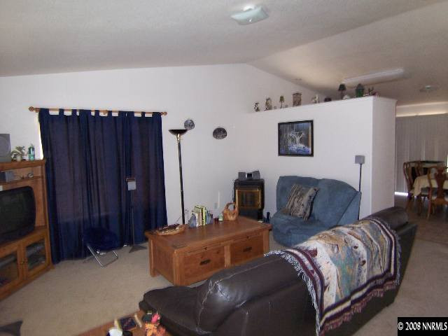 18031 Hazelnut Drive Reno, NV 89508 - Photo 4 of 9 a living room with furniture a flat screen tv and a view of kitchen