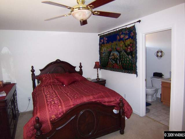 18031 Hazelnut Drive Reno, NV 89508 - Photo 5 of 9 a bedroom with a bed and a painting on the wall