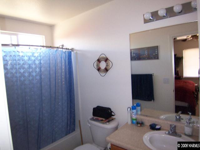 18031 Hazelnut Drive Reno, NV 89508 - Photo 8 of 9 a bathroom with a toilet sink vanity tub and mirror