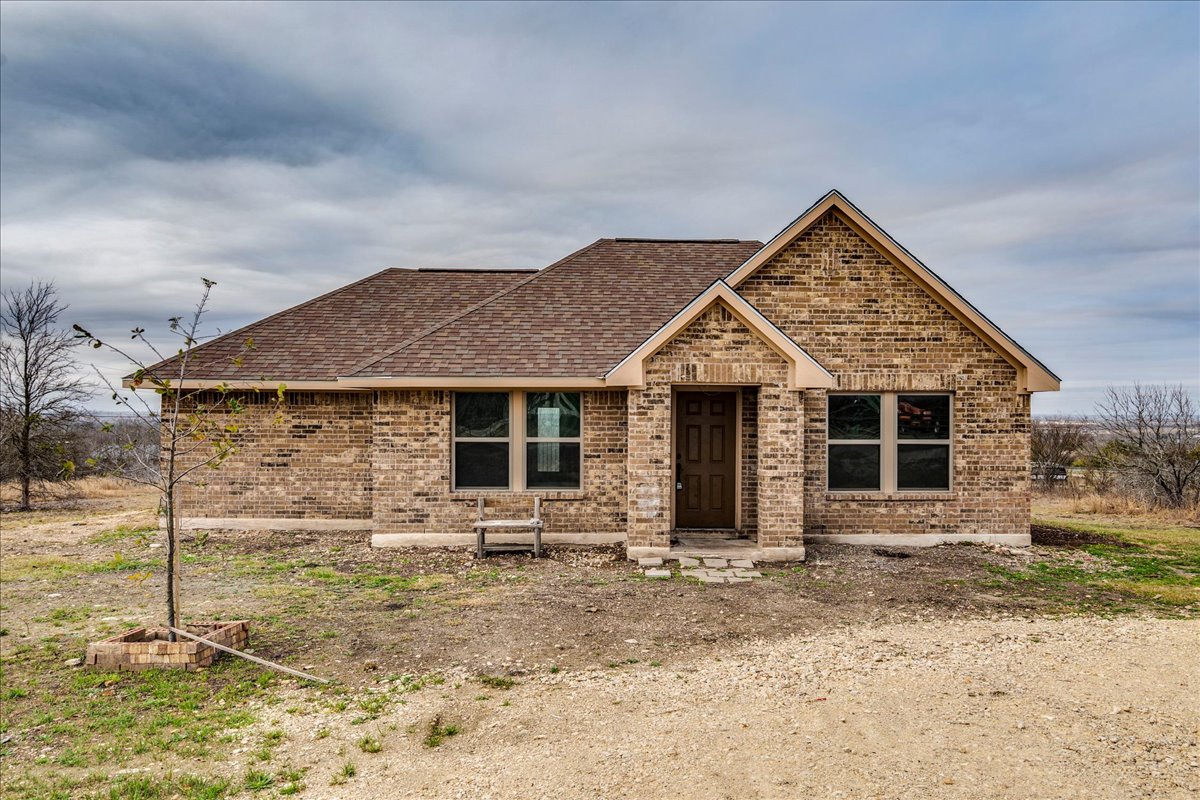 1092 Engelke Road Niederwald, TX 78640 - Photo 1 of 1 Ranch-style house with brick siding and a shingled roof