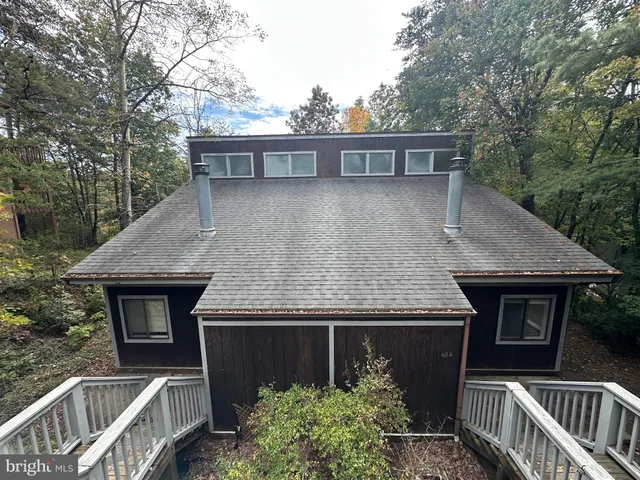 a view of a house with brick wall and a wooden fence
