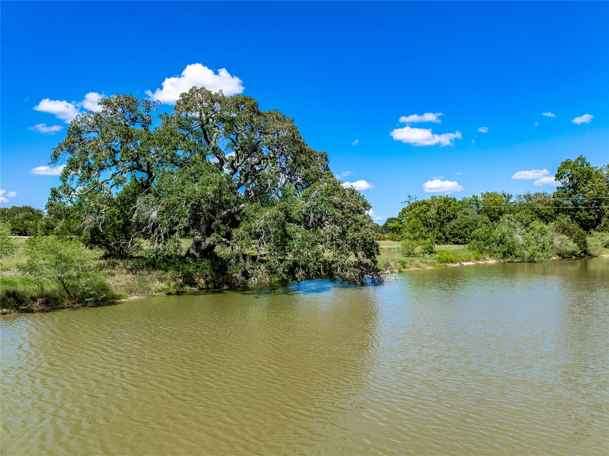 253 Cr 253 Road Weimar, TX 78962 - Photo 13 of 16 a view of a lake with a house in the background