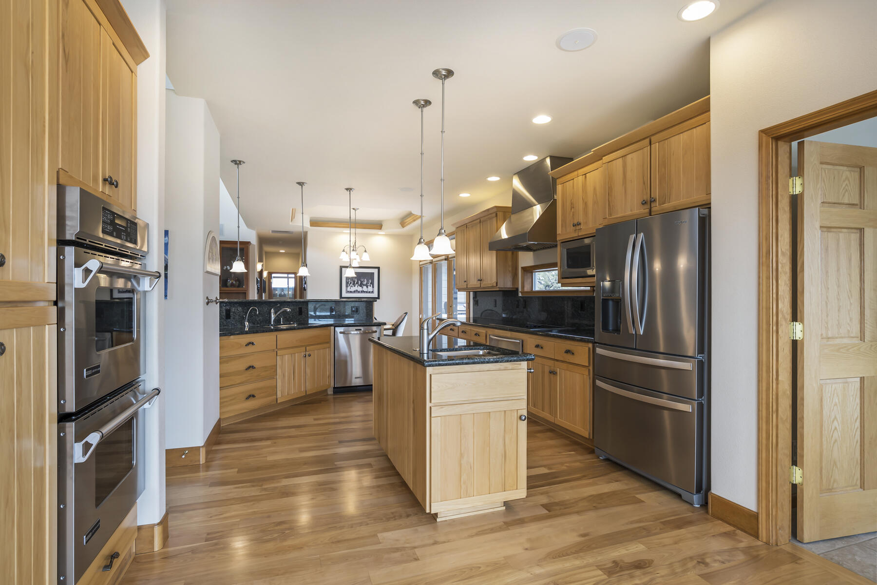 60850 Jennings Road Bend, OR 97702 - Photo 11 of 52 a kitchen with stainless steel appliances granite countertop a refrigerator a oven a sink and a stove