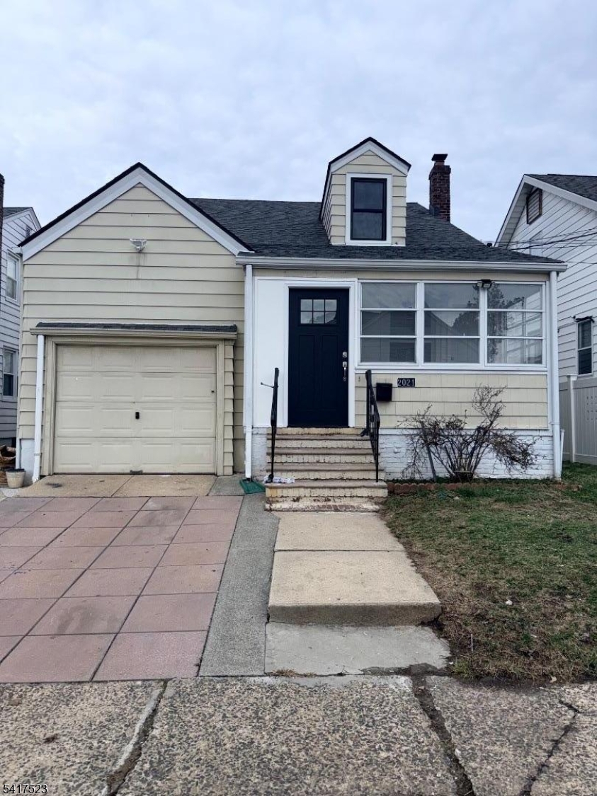 2021 Tyler Street Union, NJ 07083 - Photo 1 of 14 a front view of a house with a yard and garage