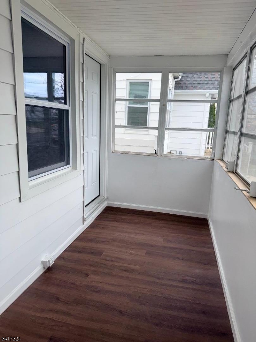2021 Tyler Street Union, NJ 07083 - Photo 2 of 14 an empty room with wooden floor and windows