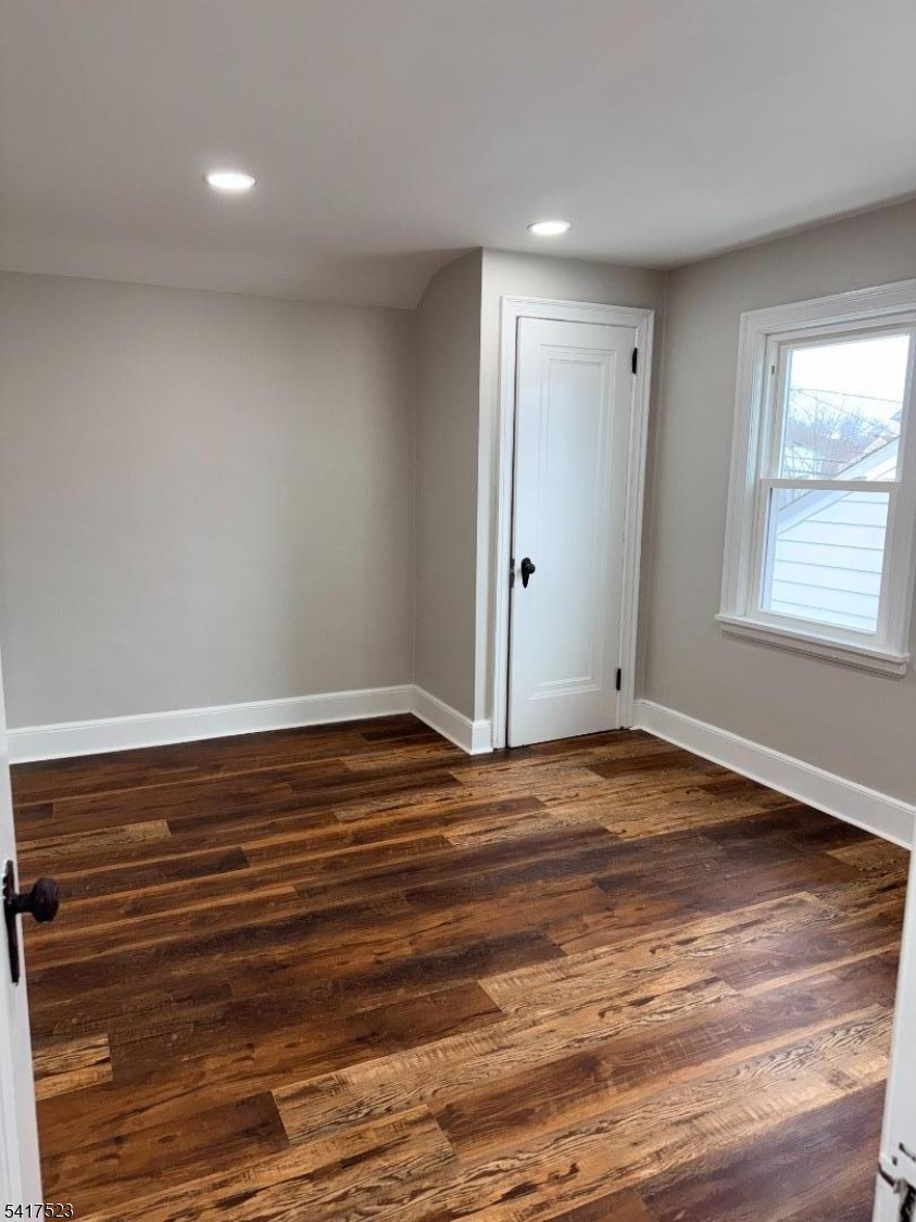 2021 Tyler Street Union, NJ 07083 - Photo 9 of 14 a view of an empty room with wooden floor and a window