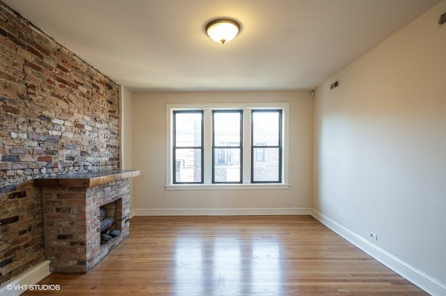 Undisclosed Address Chicago, IL 60657 - Photo 5 of 7 wooden floor fireplace and windows in an empty room
