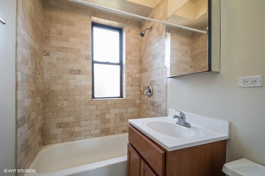 Undisclosed Address Chicago, IL 60657 - Photo 6 of 7 a bathroom with a sink toilet and shower