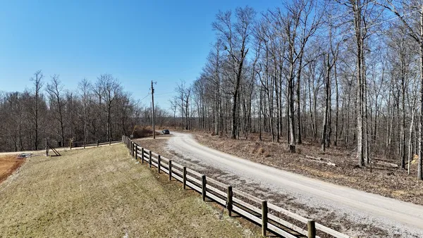 a view of a yard with wooden fence