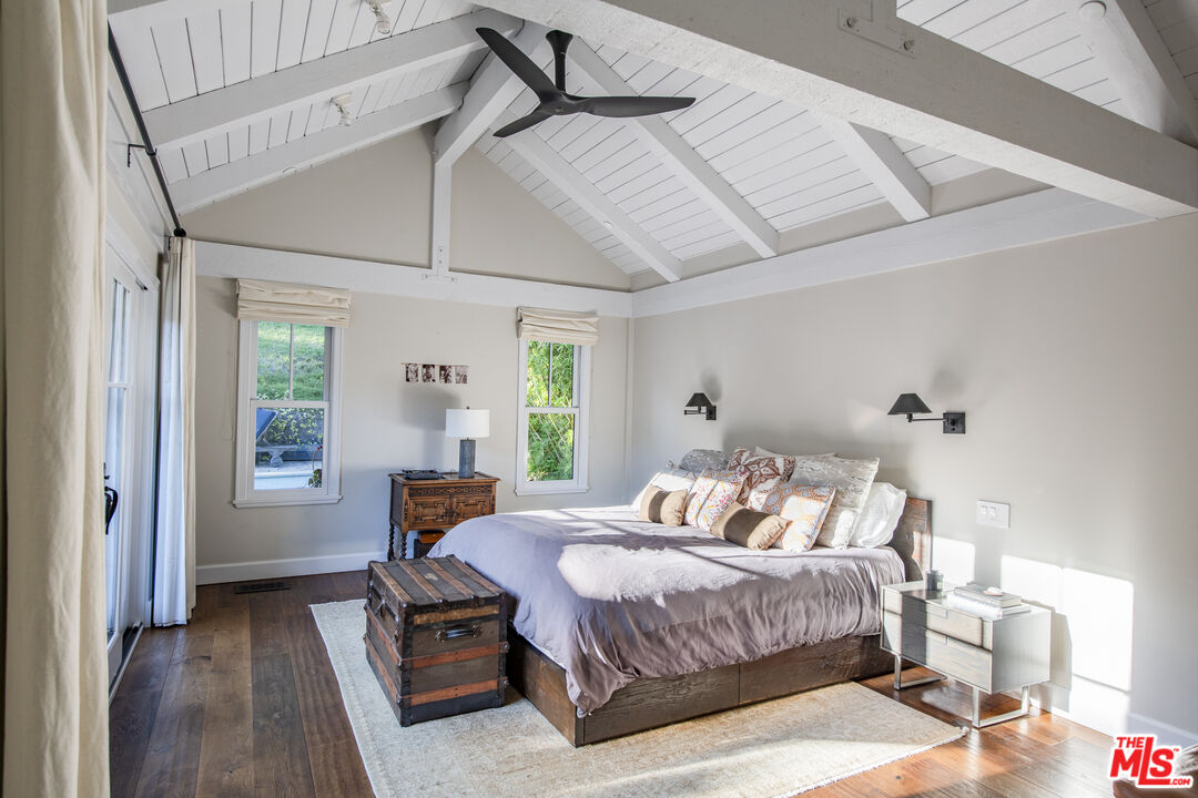 5549 Green Oak Drive Los Angeles, CA 90068 - Photo 11 of 26 a bedroom with a bed and wooden floor