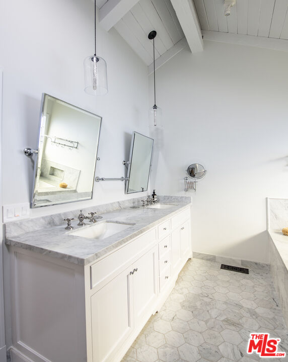 5549 Green Oak Drive Los Angeles, CA 90068 - Photo 12 of 26 a bathroom with a granite countertop sink and a mirror