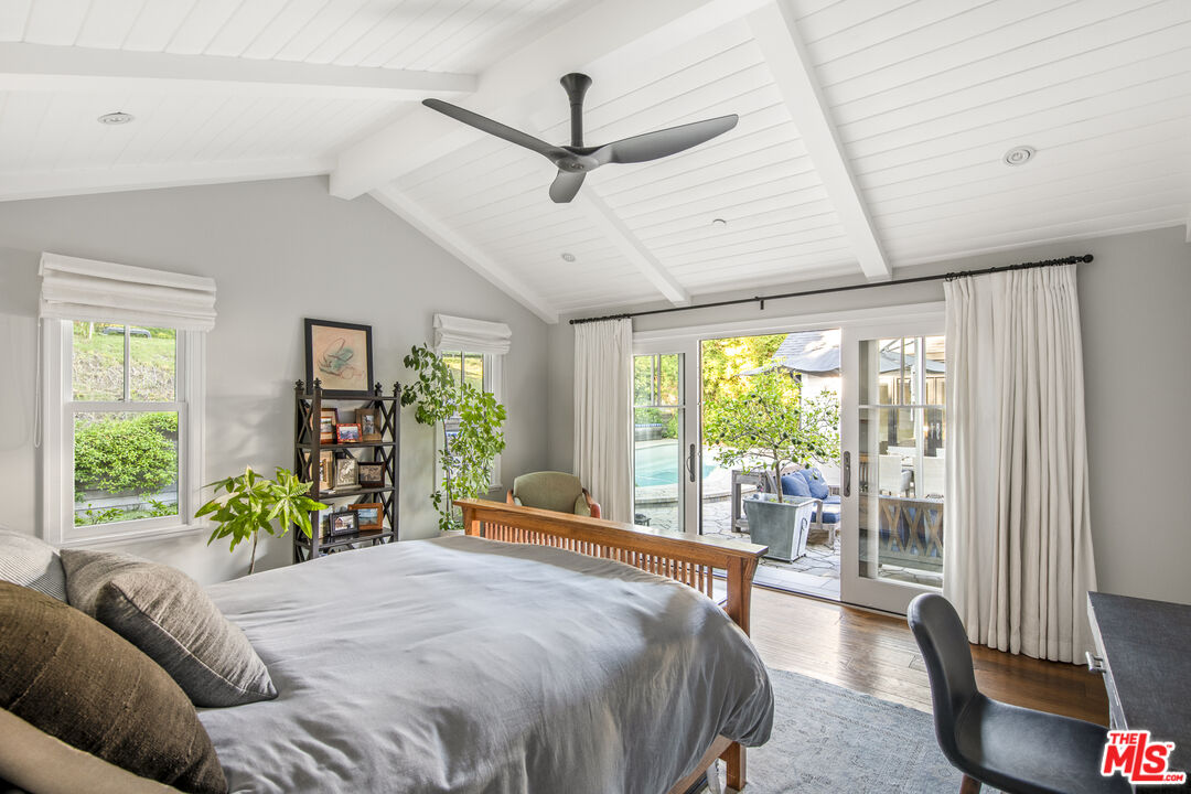 5549 Green Oak Drive Los Angeles, CA 90068 - Photo 15 of 26 a bedroom with a bed and large windows