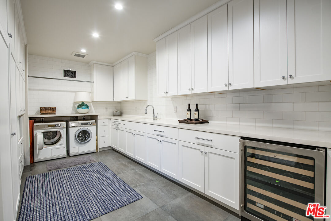 5549 Green Oak Drive Los Angeles, CA 90068 - Photo 18 of 26 a kitchen with white cabinets and white appliances