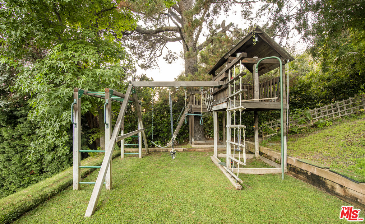 5549 Green Oak Drive Los Angeles, CA 90068 - Photo 23 of 26 a view of a house with a yard and wooden fence