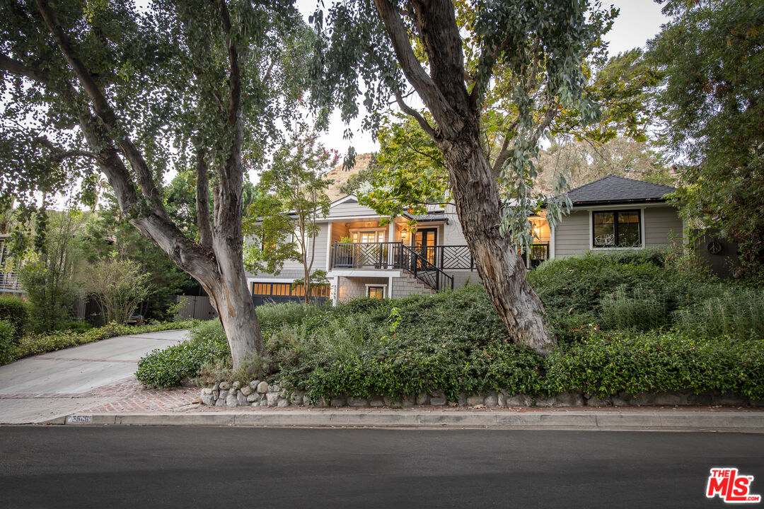 5549 Green Oak Drive Los Angeles, CA 90068 - Photo 3 of 26 a front view of a house with a yard and potted plants