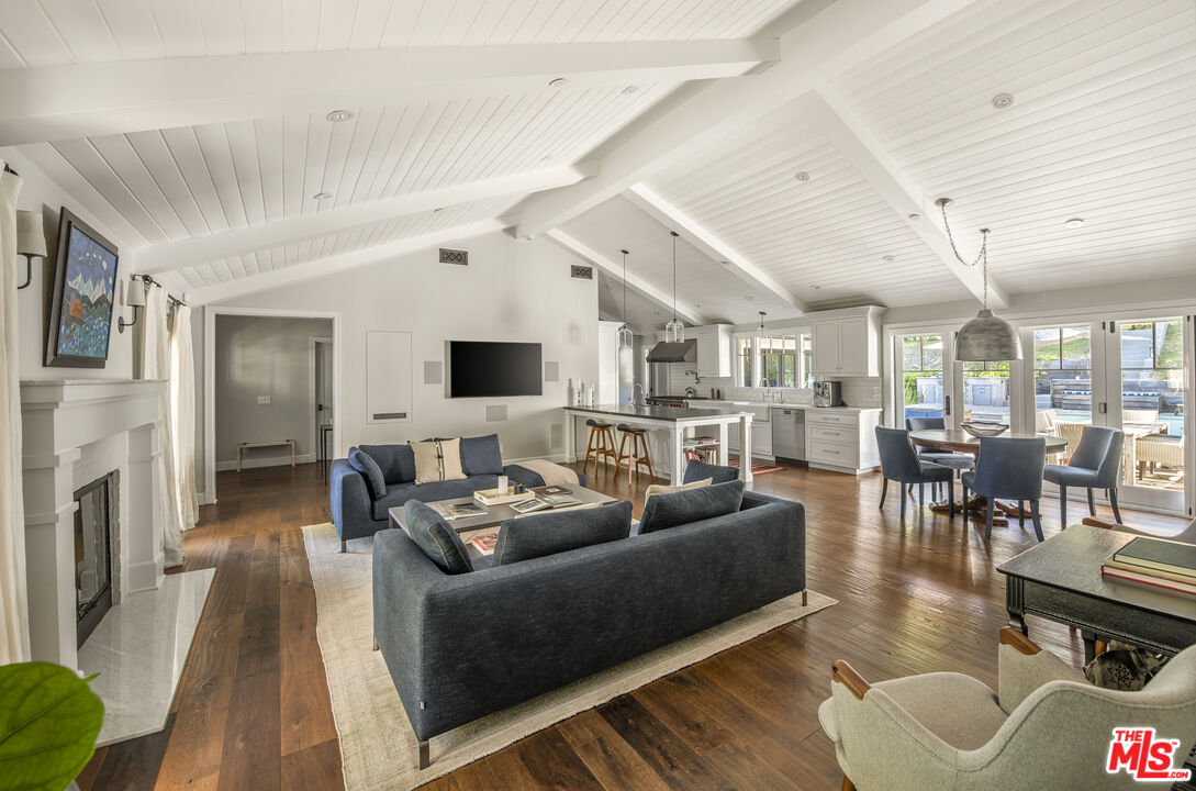 5549 Green Oak Drive Los Angeles, CA 90068 - Photo 5 of 26 a living room with furniture wooden floor and a fireplace
